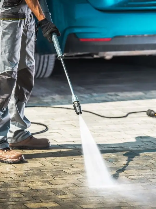 Professional yet affordable pressure washing service cleaning a residential home's exterior surfaces.
